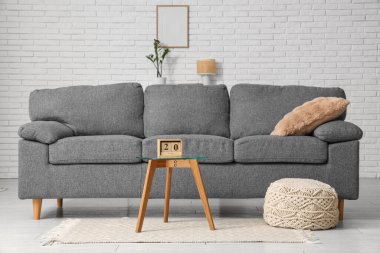 Oturma odasının içi. Masada kanepe ve küp takvimi var.