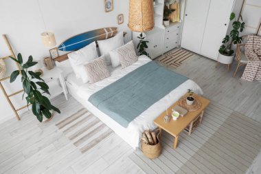 Sörf tahtası, dolap ve bank ile aydınlık yatak odasının içi