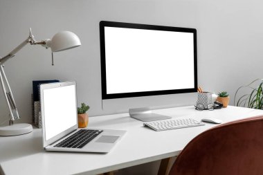 Oturma odasında dizüstü bilgisayarı olan boş bir bilgisayar monitörü.