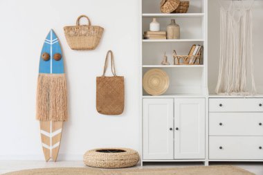 Sörf tahtası, dolap ve çantaları olan ışık odasının içinde.