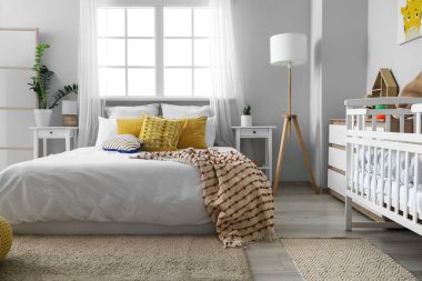 Yatak, bebek beşiği ve oyuncakları olan ışık odasının içinde.