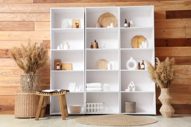 Banyo içinde raf ünitesi, masa ve otlar var.