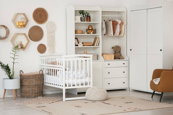 Interior of nursery with baby crib, closet and shelves