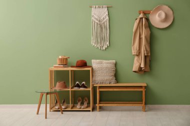 Koridorun iç tarafındaki yeşil duvarın yanında ayakta durun.