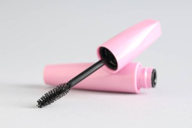 Gri arkaplanda siyah maskara, yakın plan.