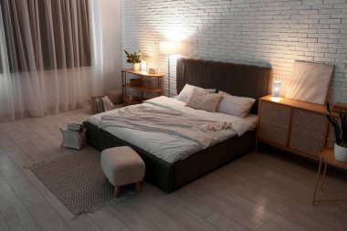 Yatak odasının iç kısmı rahat yatak odası, yumuşak puf ve geceleri parlayan lambalar