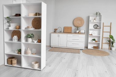 Mutfağın içinde raf, tezgah ve bitkiler var.