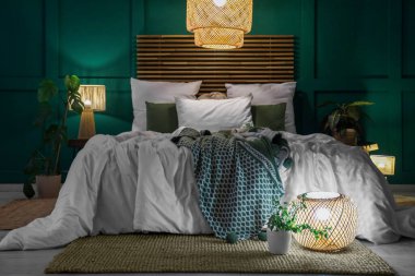 Şık bir yatak odası, rahat bir yatak odası, çiçekler ve geceleri parlayan lambalar.