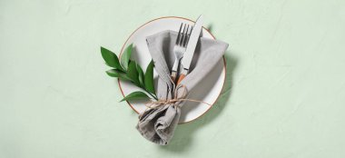 Açık yeşil arka planda taze yapraklarla güzel bir masa.