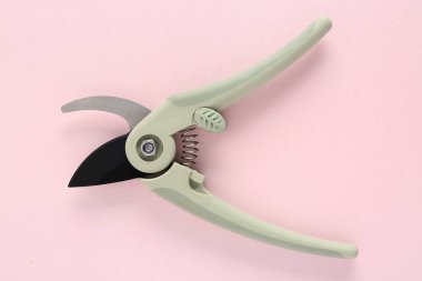 Pembe arka planda bahçıvanlık yapan gri kesiciler.