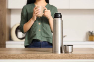 Genç bir kadının mutfağındaki termos.