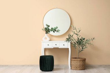 Makyaj masası, ayna ve bitkilerin olduğu soyunma odası.