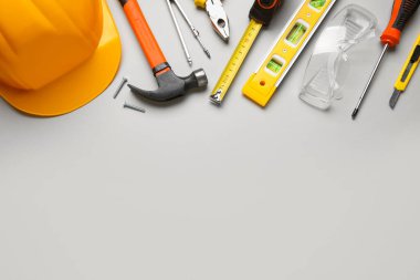 Gri arkaplanda inşaat araçları ve sabit başlık
