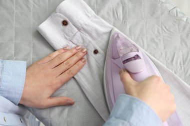 Ütülü gömlek giyen kadın evde, üst manzaralı.