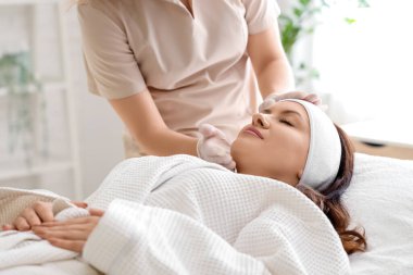 Salonda müşterisi olan bir kadın güzellik uzmanı.