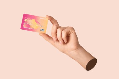 Renk arkaplanında kredi kartı olan bir kadın.