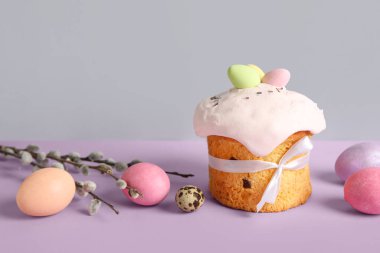 Composition with delicious Easter cake, pussy willow branch and painted eggs on color background. Closeup