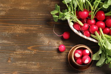 Tahta arka planda olgun turp kasesi ve sepeti.