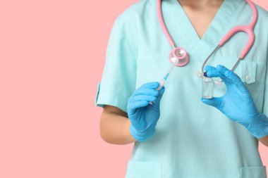 Pembe arka planda steteskop, ampul ve şırınga kullanan kadın kardiyolog, yakın plan.