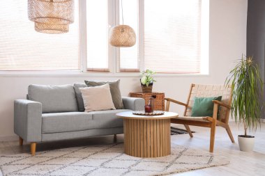 Oturma odasında rahat bir koltuk, kanepe ve masa.