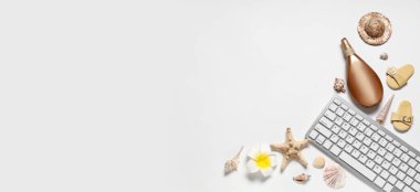 Beyaz arkaplan üzerinde bilgisayar klavyesi, güneş kremi ve deniz kabukları ile yaz kompozisyonu