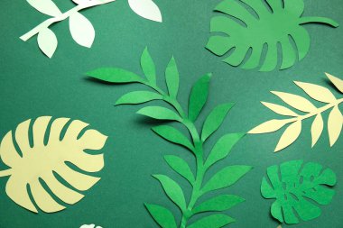 Yeşil arkaplanda güzel origami yaprakları