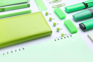 Beyaz arkaplanda renkli kırtasiye malzemesi olan kompozisyon, yakın plan