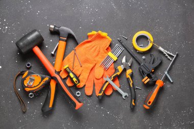 Siyah grunge arka planında eldivenler ve inşaat araçları