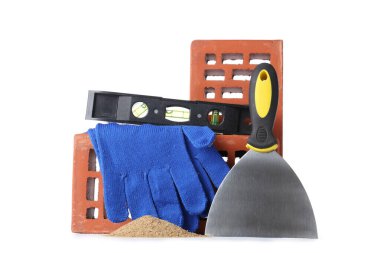 Beyaz arkaplanda eldivenler, tuğlalar ve inşaat araçları