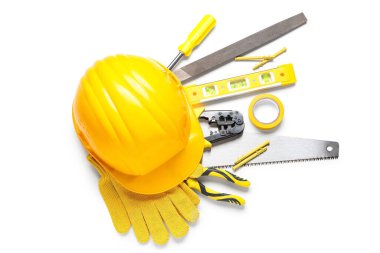 Beyaz arka planda sert şapka, eldivenler ve inşaat araçları