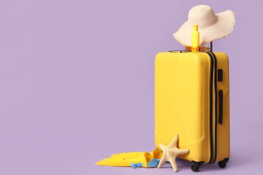 Plaj aksesuarları, güneş kremi ve leylak arkaplanlı denizyıldızı.