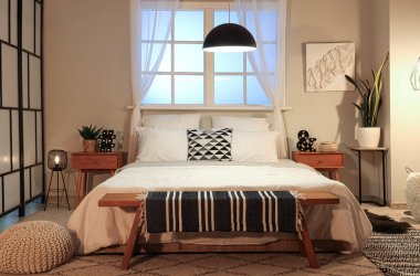 Büyük yataklı ve parlak lambalı modern yatak odası.