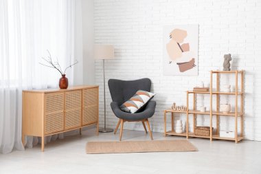 Odanın içinde ahşap raf ünitesi, koltuk ve tuvalet var.