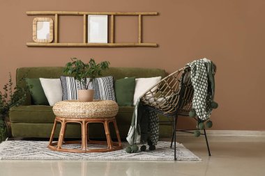 Oturma odasında yeşil kanepe, koltuk ve merdiven var.