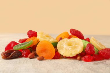 Gri grunge masasında farklı kurutulmuş meyveler, yakın plan.