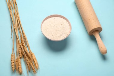 Mavi arka planda un, merdane ve buğday kulaklı kase