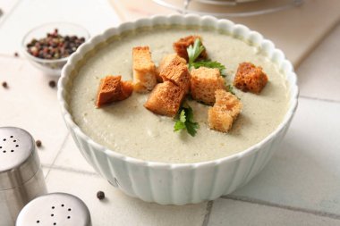 Beyaz fayanslı bir kase kremalı çorba.