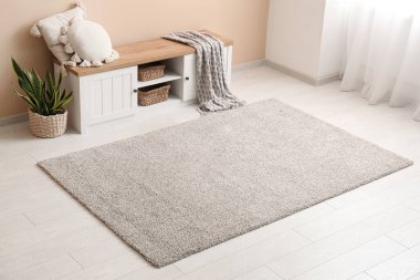 Oturma odasının iç tarafında yastık, ekose ve halı var.