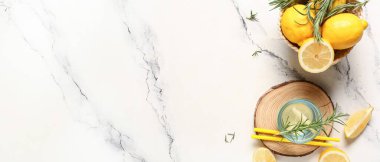 Beyaz arka planda biberiyeli ve limonlu bir bardak taze limonata.