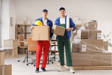 Bükük ambalajlı ve kutulu erkek yükleyiciler ofiste.