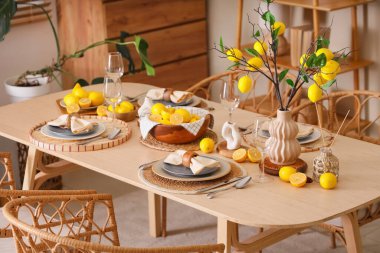 Yemek odasında bir sürü taze turta ve güzel limon dallarıyla süslenmiş şık masa dekorasyonu.