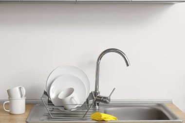 Mutfakta lavabonun yanında temiz tabaklar ve lastik eldivenlerle doldur.