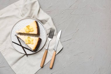 Gri arka planda tatlı vanilyalı cheesecake tabağı