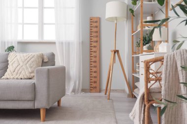 Stadyum ölçer, lamba ve raf üniteli oturma odasının içi.