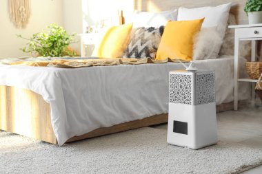 Halıdaki modern hava nemlendirici açık yatak odasında.