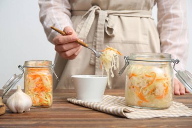 Mutfaktan lahana turşusu alan bir kadın. Yakın çekim.