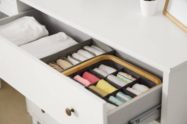 Açık sandık dolusu kıyafet, yakın plan.