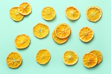 Dried orange slices on turquoise background
