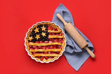 Lezzetli Amerikan bayrağı turtası ve kırmızı arka planda merdane. Bağımsızlık Günü kutlamaları