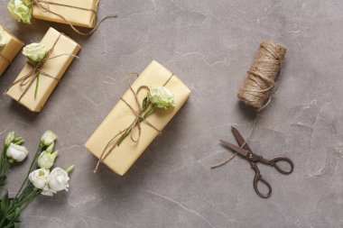 Gri arka planda güzel beyaz güller olan hediye kutuları. Uluslararası Kadınlar Günü